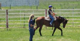 giving lessons to a riding student