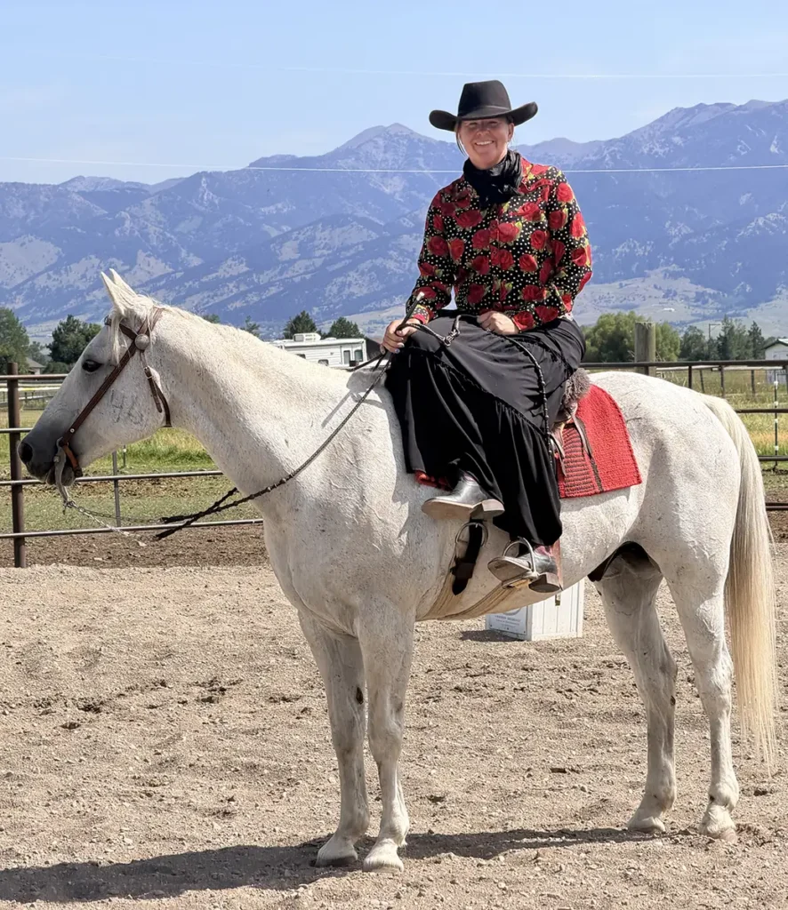Gray gelding with a side-saddle rider