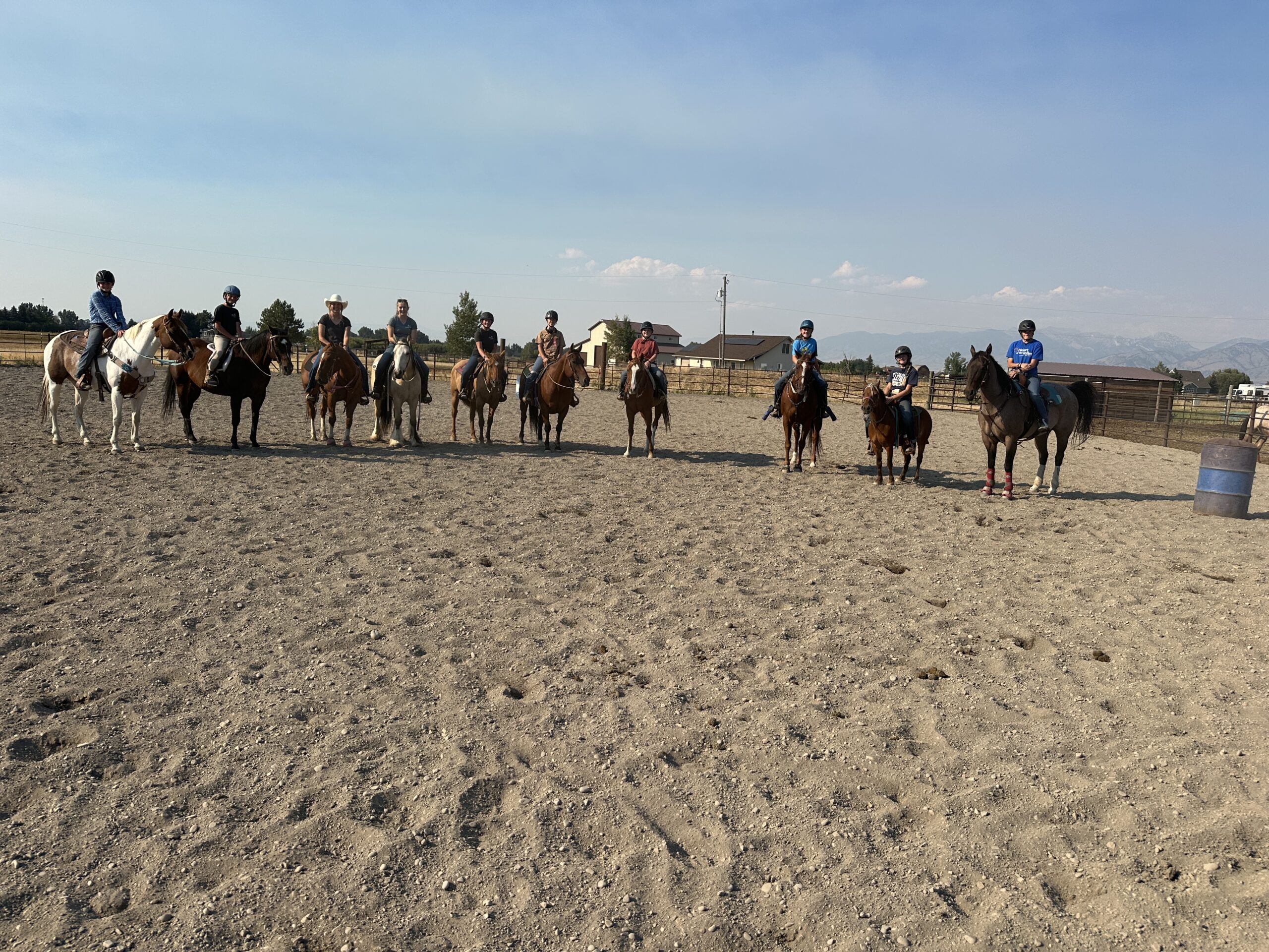 Group of riders standing in an arena.