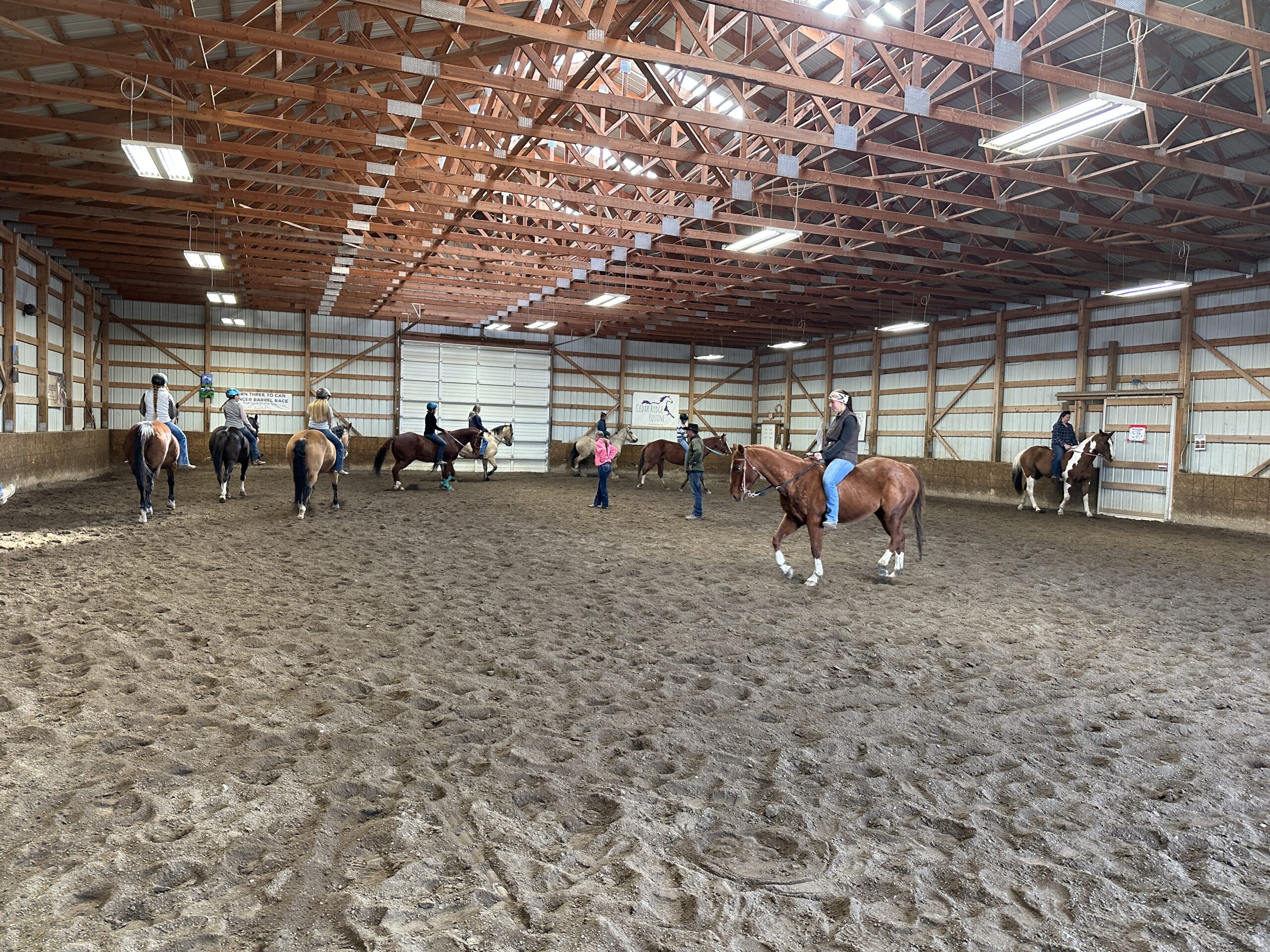 Riders riding horses bareback in an arena.